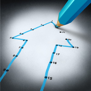 Success strategy and step by step business planning as a blue pencil drawing connection lines to connect the dots on a puzzle shaped as an arrow going up as a financial metaphor for a successful planned personal project.